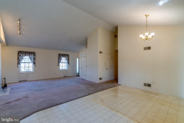 spare room with visible vents, a notable chandelier, and carpet