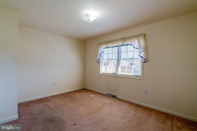 spare room with visible vents, baseboards, and carpet floors