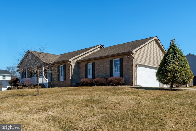 view of front of home with a garage, brick siding, and a front lawn