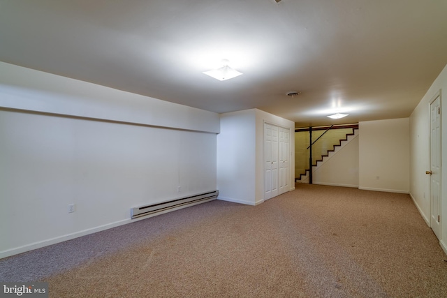 finished below grade area with baseboard heating, stairway, baseboards, and carpet floors