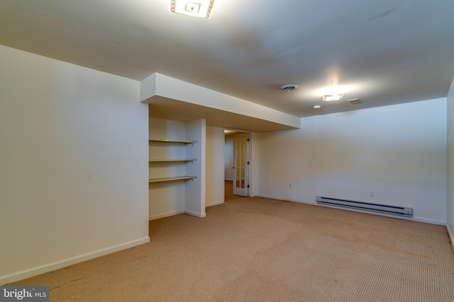 finished basement with light carpet, visible vents, baseboards, and a baseboard radiator