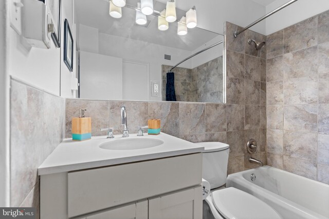 2601 Pennsylvania Ave Unit 952, Philadelphia, PA 19130 - bathroom featuring shower / bath combination with curtain, vanity, backsplash, toilet, and tile walls
