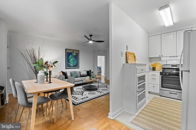 2601 Pennsylvania Ave Unit 952, Philadelphia, PA 19130 - kitchen featuring stainless steel gas range, white cabinets, freestanding refrigerator, a ceiling fan, and baseboards