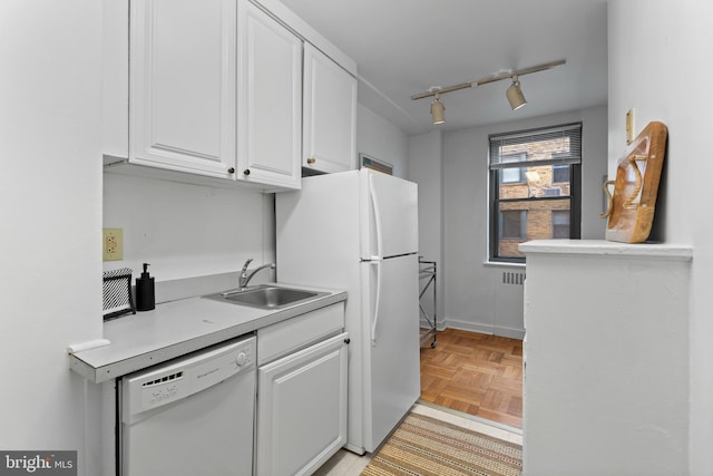2601 Pennsylvania Ave Unit 952, Philadelphia, PA 19130 - kitchen featuring white appliances, a sink, white cabinets, light countertops, and rail lighting