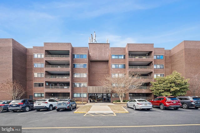 view of building exterior with uncovered parking