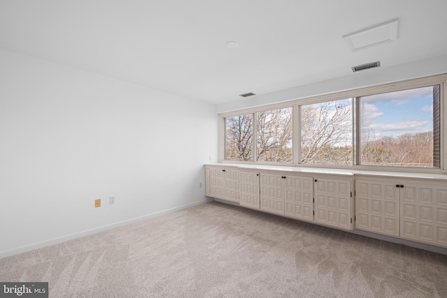 unfurnished bedroom with light colored carpet, visible vents, and baseboards