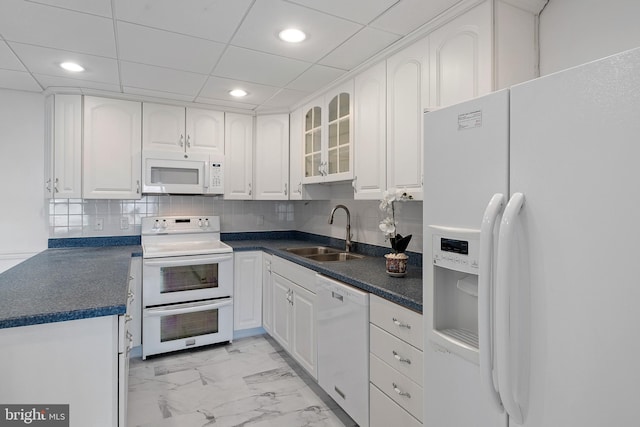 kitchen featuring marble finish floor, white appliances, a sink, and white cabinets