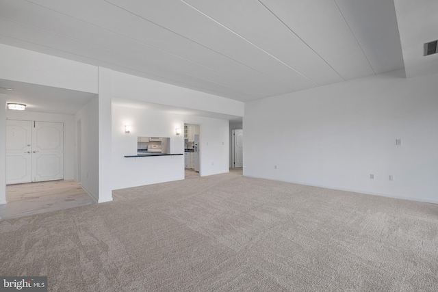 unfurnished living room with light carpet and visible vents