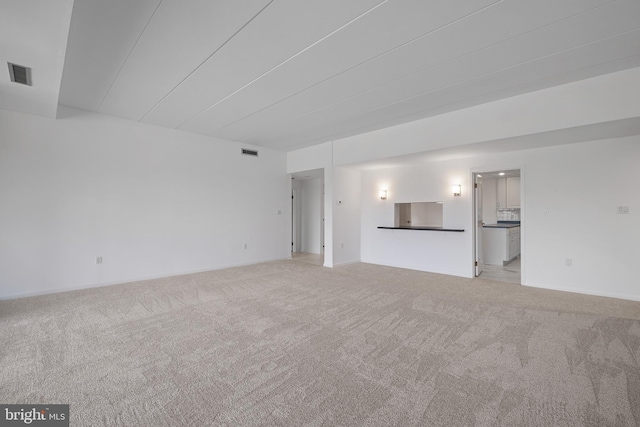 unfurnished living room featuring light carpet and visible vents