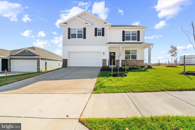 view of front facade with an attached garage, stone siding, concrete driveway, and a front yard