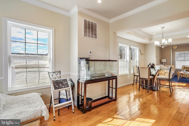 dining space with light wood-style flooring, visible vents, and a healthy amount of sunlight