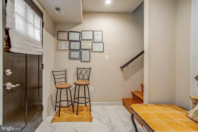 interior space with marble finish floor, visible vents, and baseboards