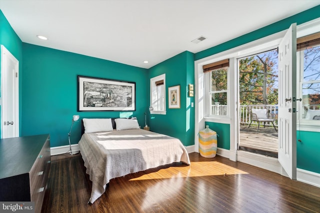 bedroom with visible vents, baseboards, dark wood-style floors, and access to outside