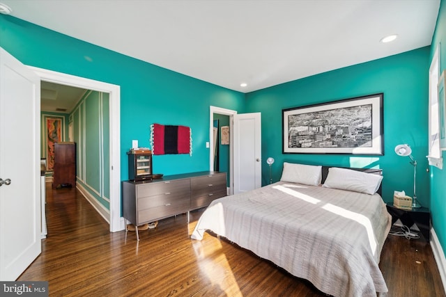 bedroom with recessed lighting, baseboards, and wood finished floors