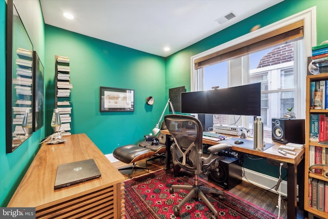 home office with recessed lighting, visible vents, and wood finished floors