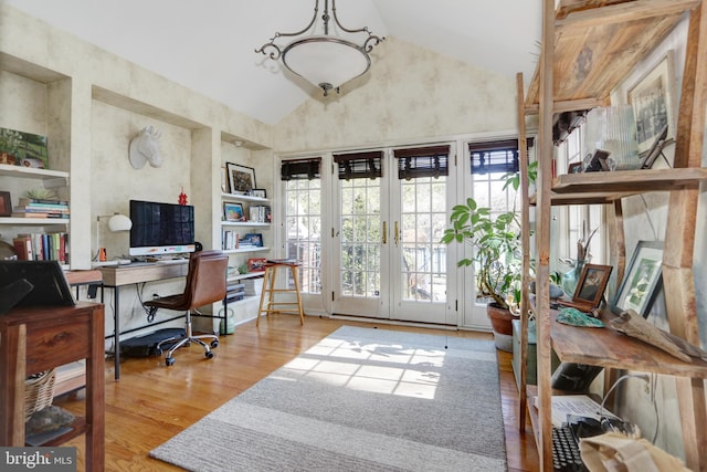 office featuring high vaulted ceiling, wood finished floors, and french doors