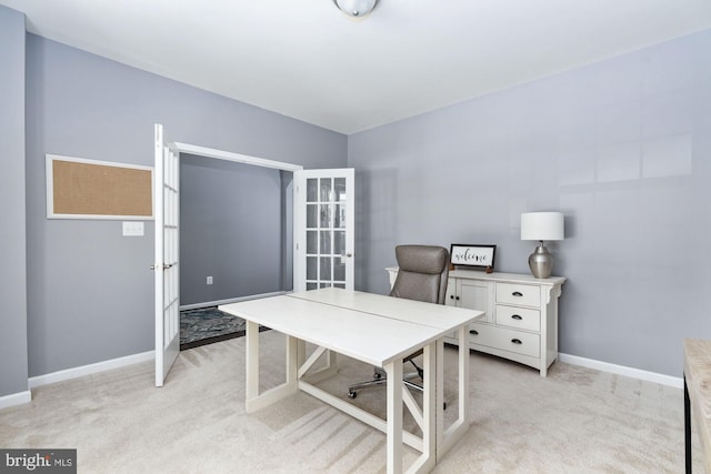 home office featuring light colored carpet and baseboards