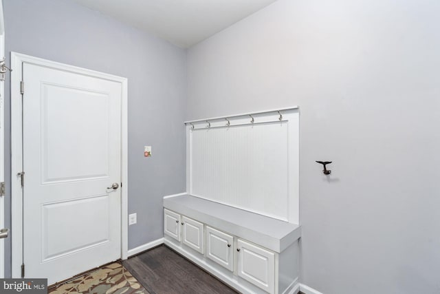 mudroom with dark wood-style floors and baseboards