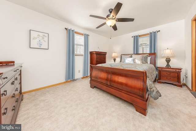 bedroom featuring baseboards, a ceiling fan, and light colored carpet