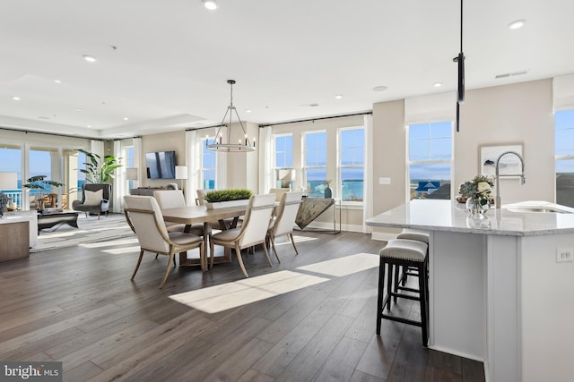 dining room featuring recessed lighting, dark wood-style flooring, visible vents, and a healthy amount of sunlight