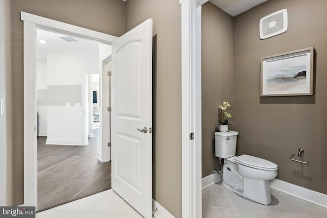 bathroom with visible vents, tile patterned flooring, toilet, and baseboards