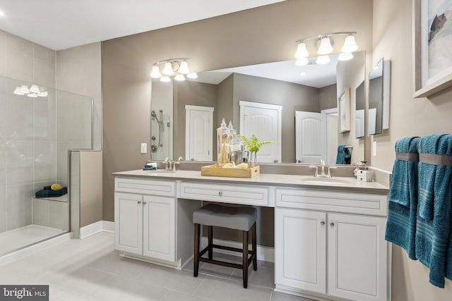 full bathroom with double vanity, a stall shower, a sink, and tile patterned floors