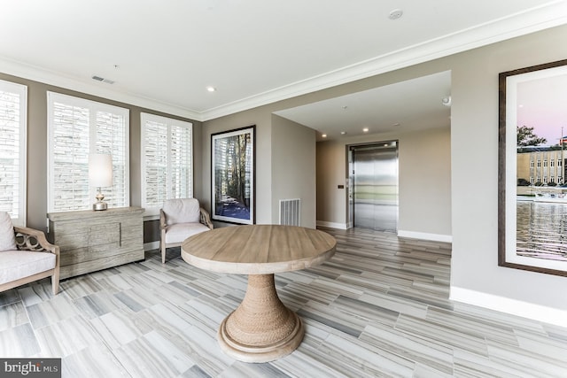 living area with crown molding, baseboards, visible vents, and elevator