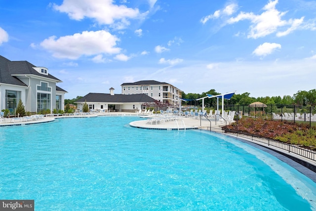 community pool with fence and a patio