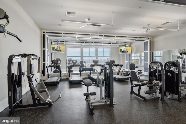 workout area featuring a healthy amount of sunlight, visible vents, and a ceiling fan