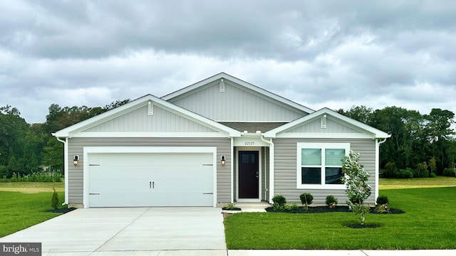 ranch-style home featuring a garage, concrete driveway, roof with shingles, and a front yard