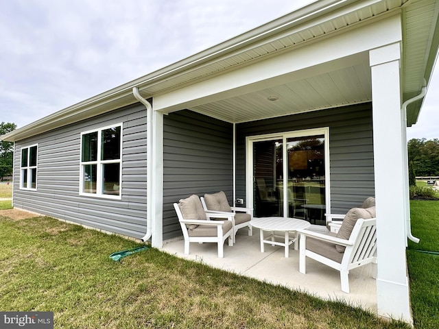 rear view of house featuring a patio and a lawn