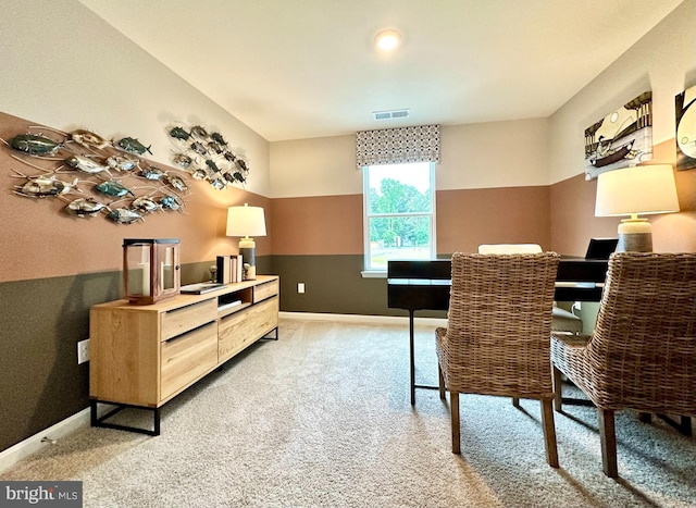 office space featuring visible vents, light carpet, and baseboards