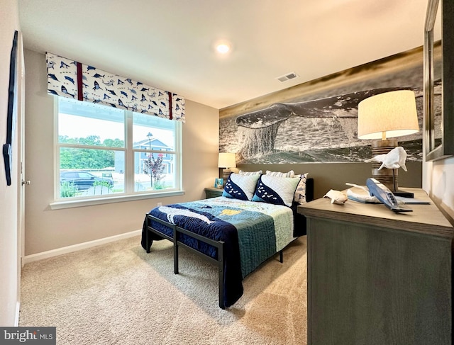 carpeted bedroom with visible vents and baseboards