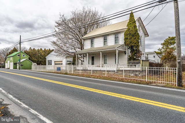 view of front of property featuring a porch and a fenced front yard