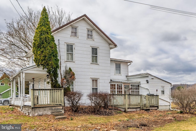 back of property featuring a porch