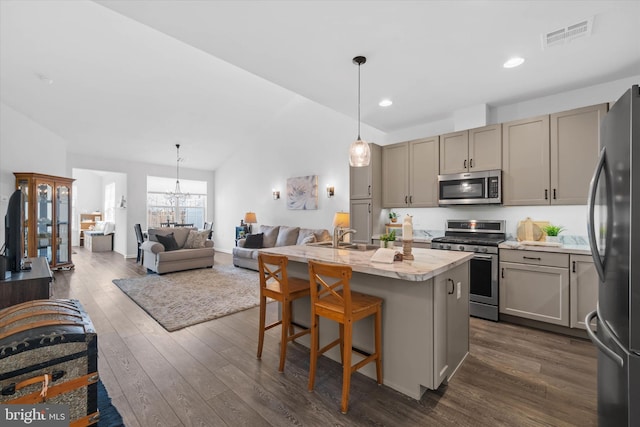 kitchen with dark wood-style floors, visible vents, gray cabinetry, appliances with stainless steel finishes, and open floor plan