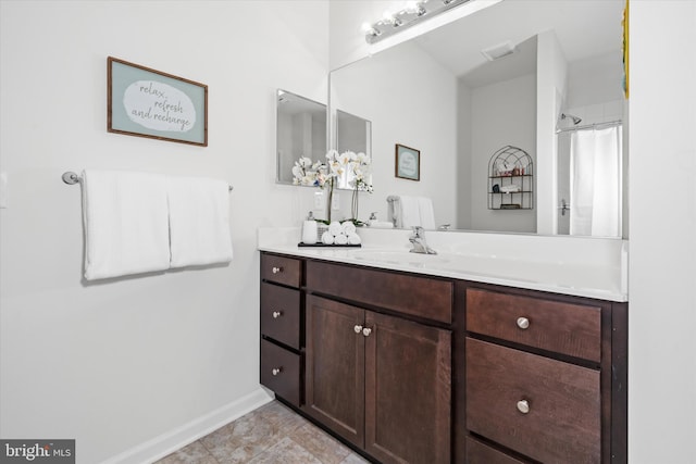 bathroom with visible vents, baseboards, and vanity