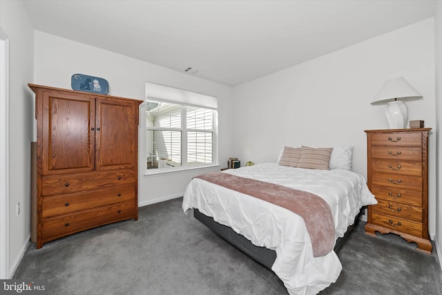 carpeted bedroom with visible vents and baseboards