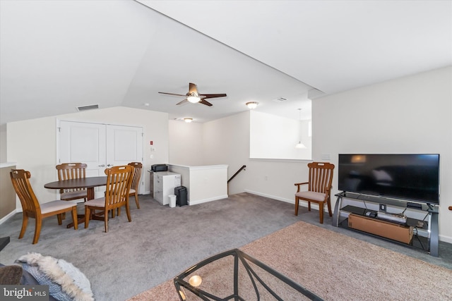 carpeted living area with a ceiling fan, lofted ceiling, visible vents, and baseboards