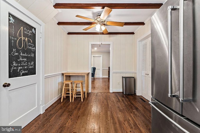 interior space with crown molding, baseboards, beamed ceiling, dark wood-style floors, and a ceiling fan