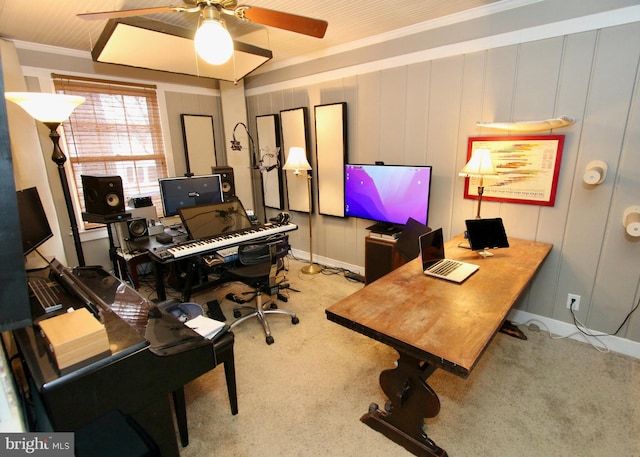 office area with a ceiling fan, crown molding, and carpet