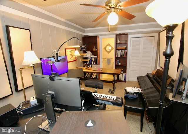 office area with ceiling fan, carpet, and ornamental molding