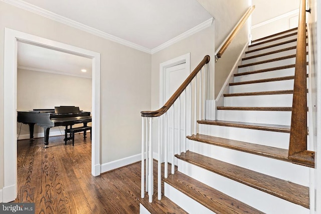 stairs featuring crown molding, wood finished floors, and baseboards