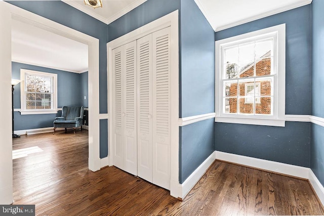 hall with baseboards, ornamental molding, and dark wood-style flooring