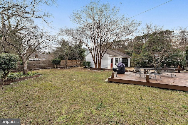 view of yard with an outdoor structure, fence, and a wooden deck