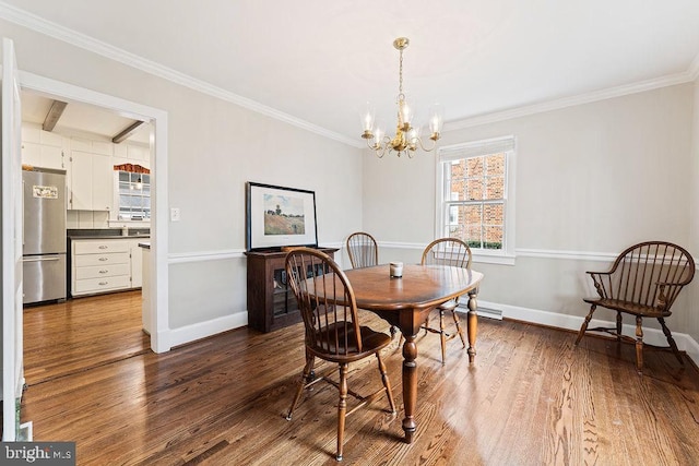 dining space with wood finished floors, baseboards, a chandelier, and ornamental molding