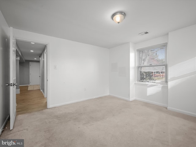 unfurnished room featuring visible vents, baseboards, and carpet