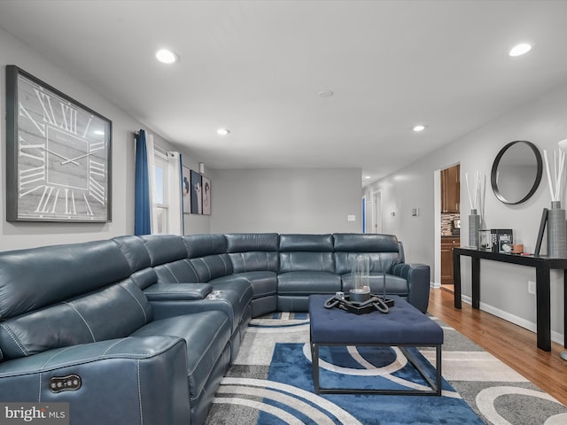 living room with recessed lighting, baseboards, and wood finished floors