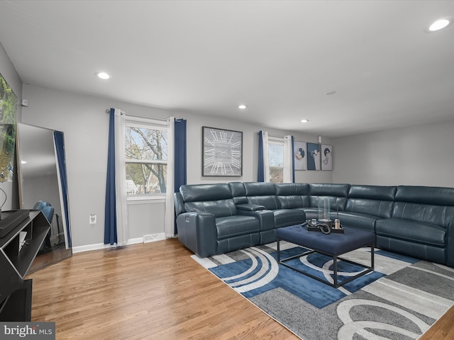 living room featuring recessed lighting, wood finished floors, and baseboards