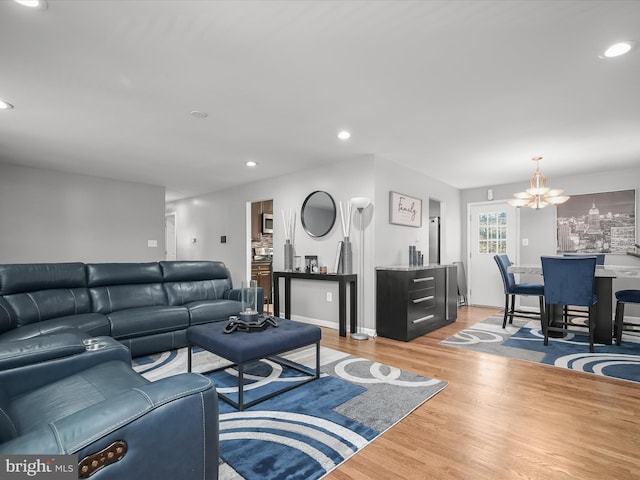 living room featuring a chandelier, recessed lighting, and light wood finished floors